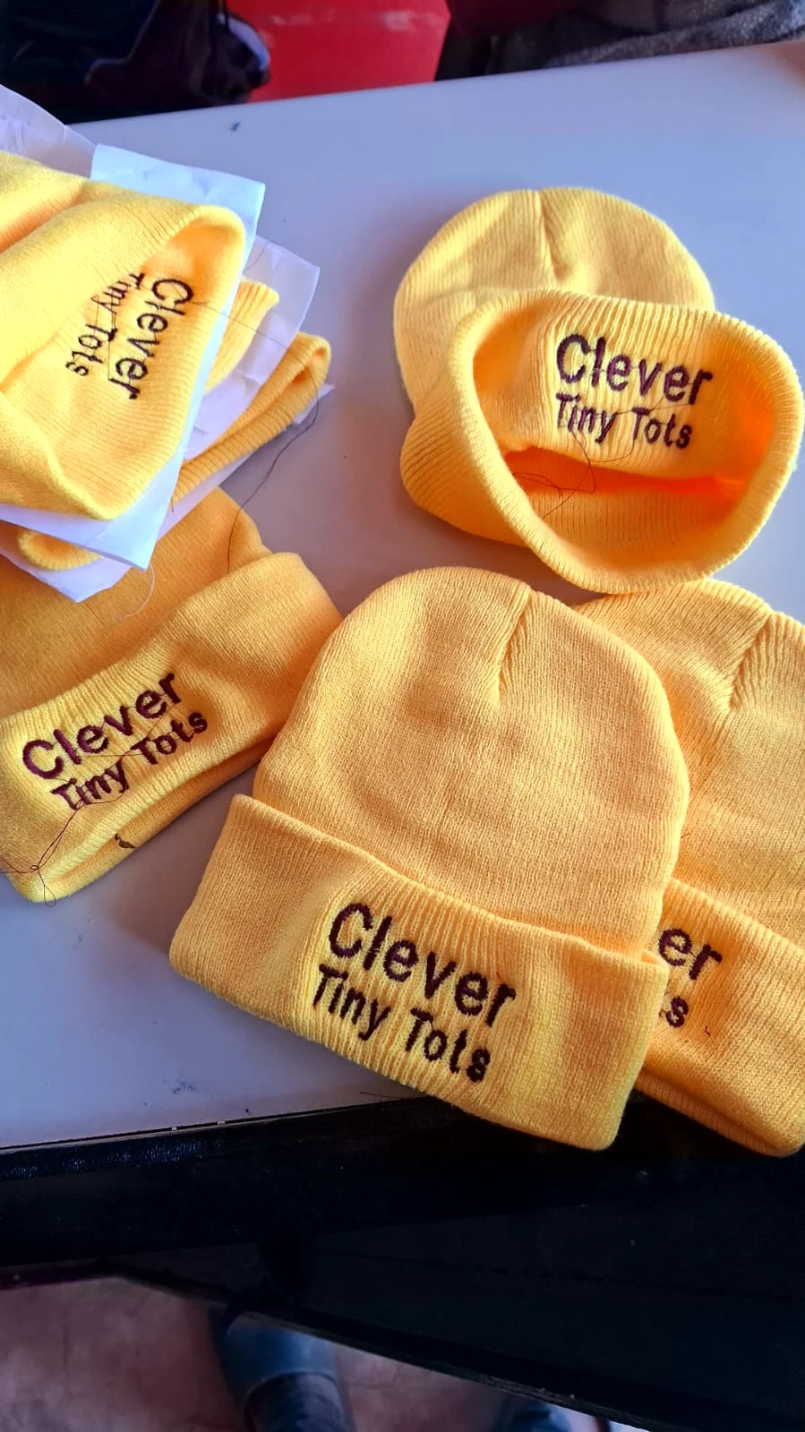 Team shirts with embroidered lettering.